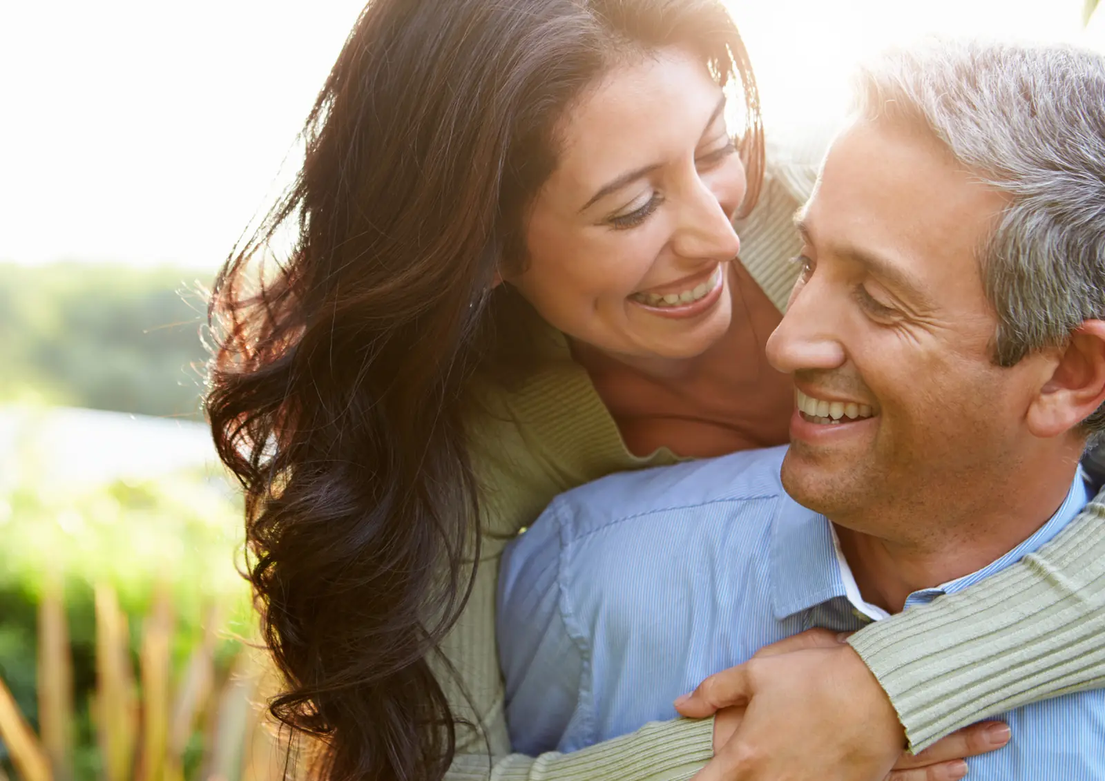 Smiling couple embracing outdoors