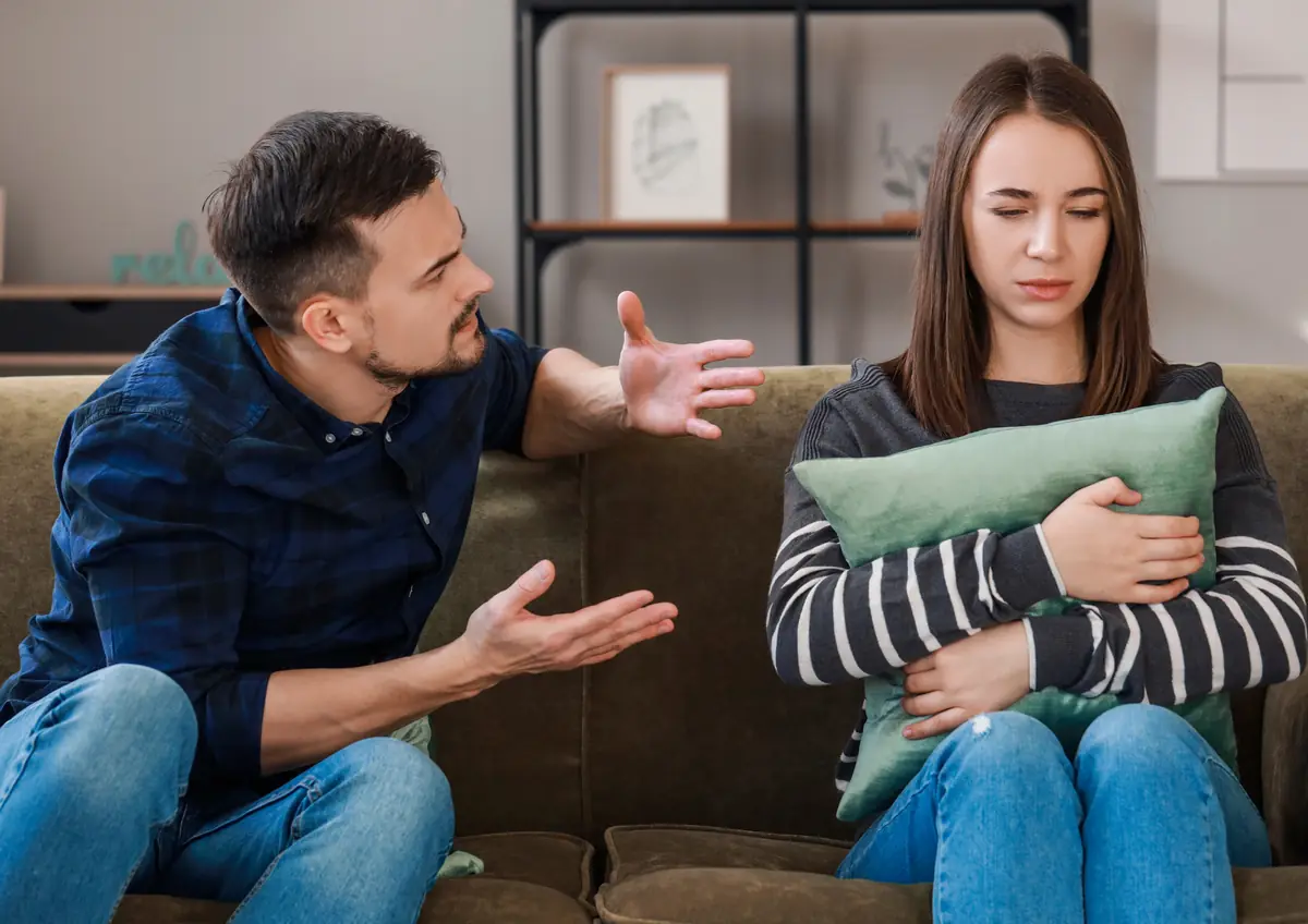 Couple arguing on a couch